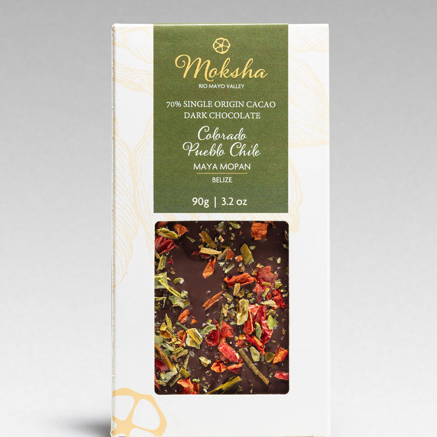 Moksha Pueblo Chile chocolate bar packaging with a gray background