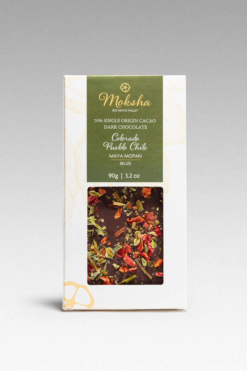 Moksha Pueblo Chile chocolate bar packaging with a gray background