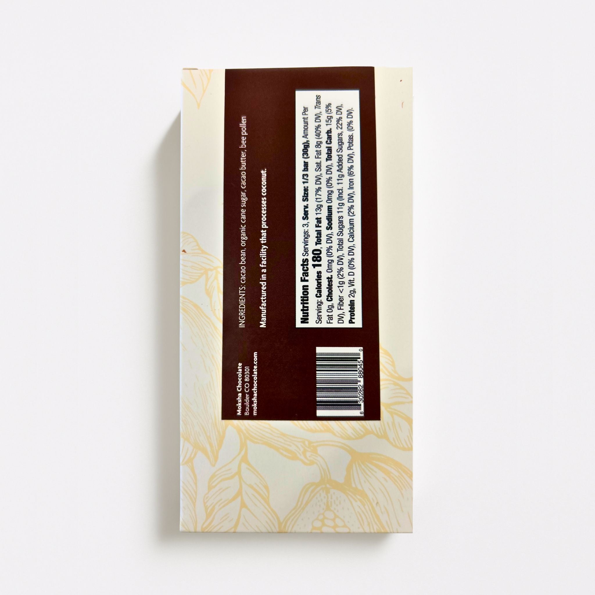 Back of Moksha Chocolate Bee Pollen Bar packaging showing ingredients list, nutrition facts, and brand information on a white background.
