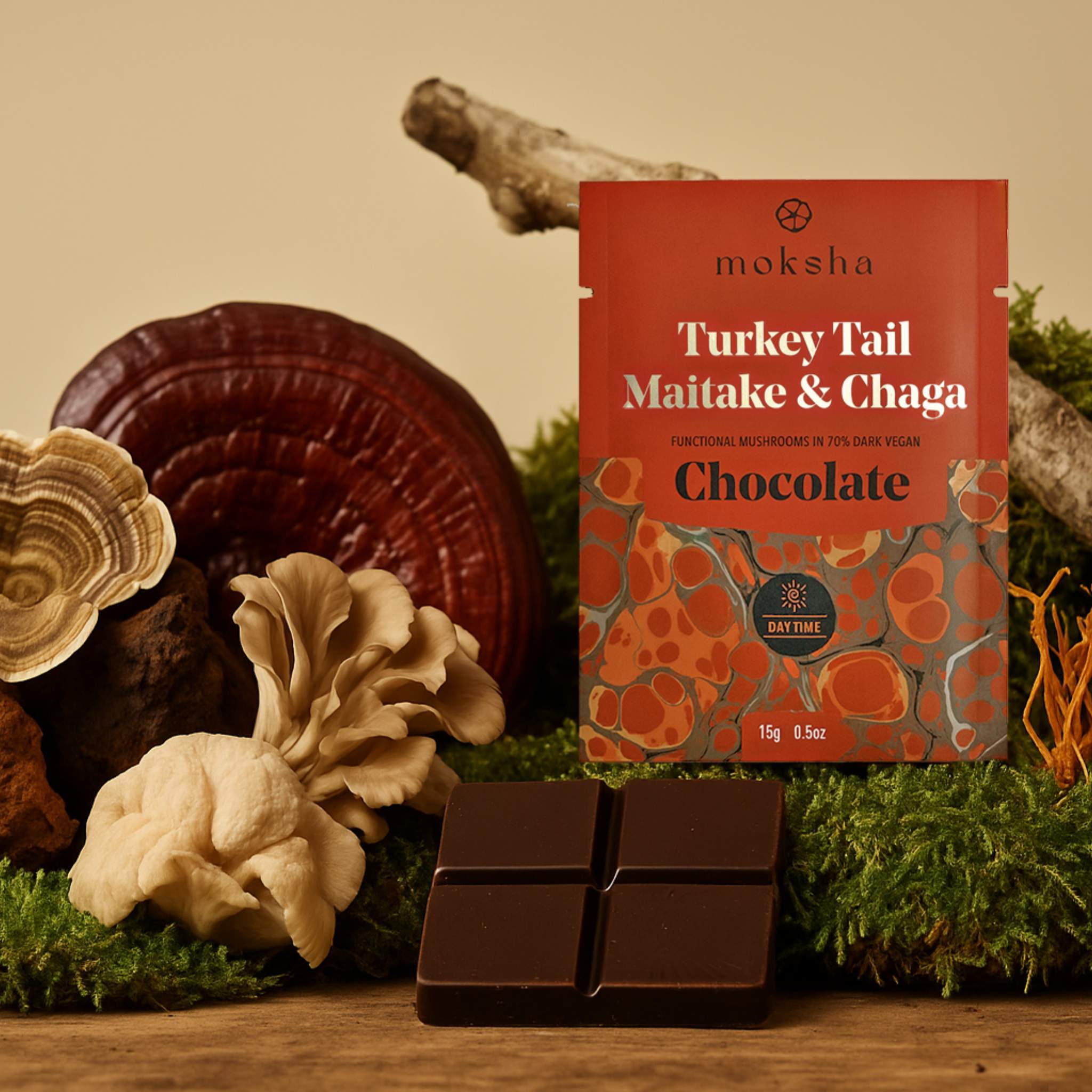 Moksha Turkey Tail Maitake & Chaga chocolate packaging with chocolate bars and mushrooms on a natural background