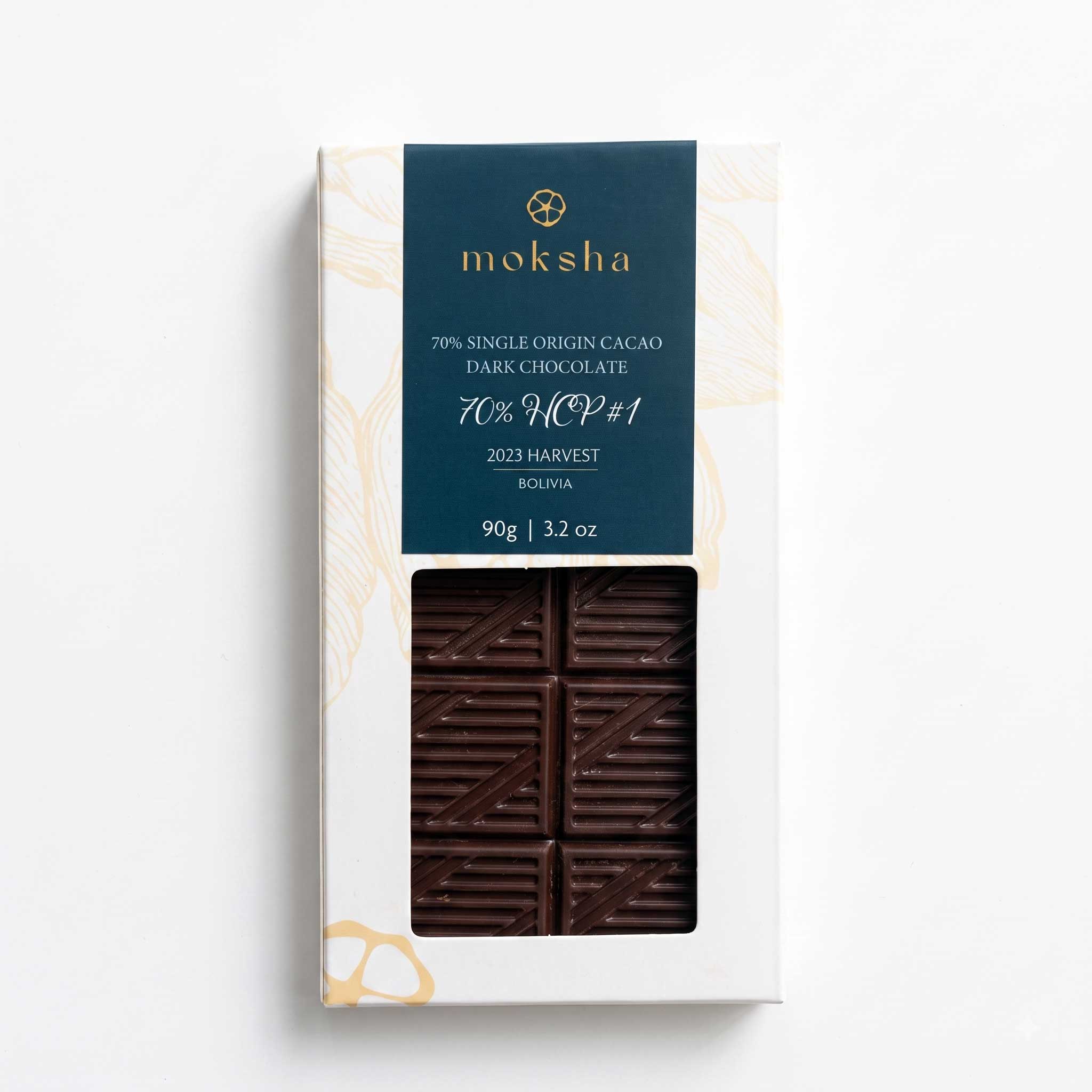 Moksha 70% HCP #1 2023 Harvest Bolivia Single Origin Dark Chocolate bar, 90g (3.2 oz), in packaging with a window showing the chocolate.