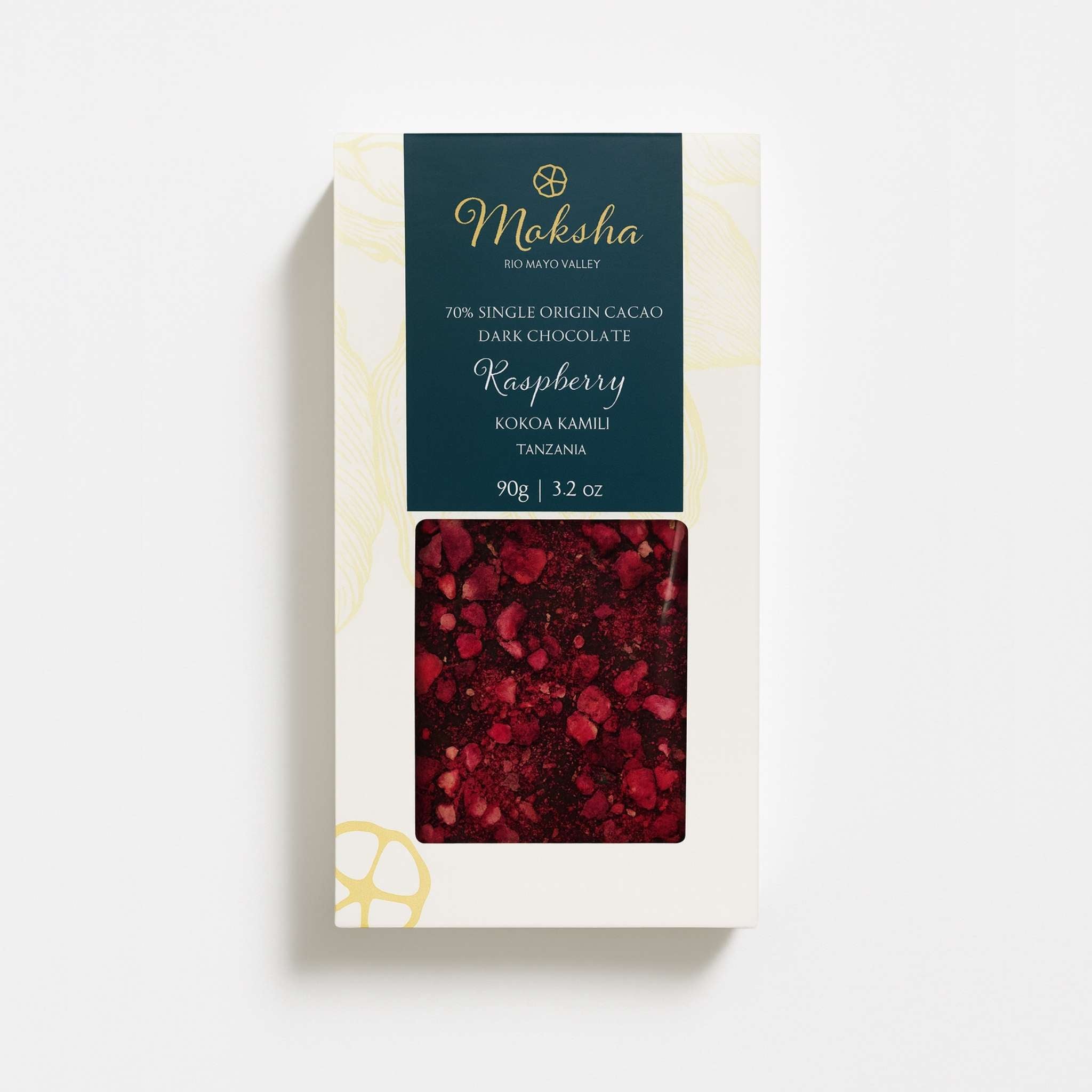 Moksha 70% Raspberry dark chocolate bar made with Kokoa Kamili Tanzanian cacao, shown in white packaging with a teal label and a clear window revealing the raspberry-topped chocolate.