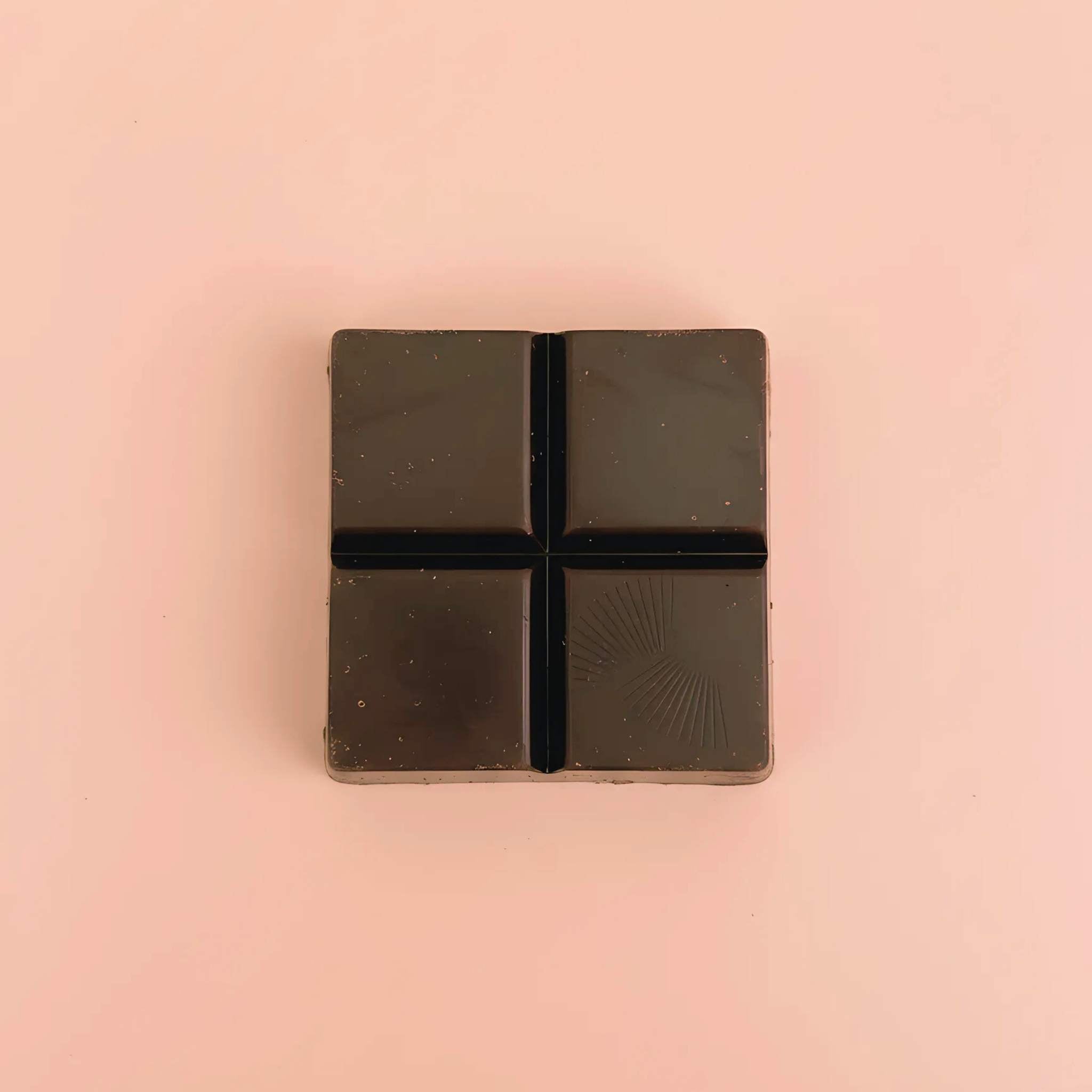 Unwrapped Moksha Turkey Tail, Maitake, and Chaga functional mushroom chocolate showing dark chocolate square.