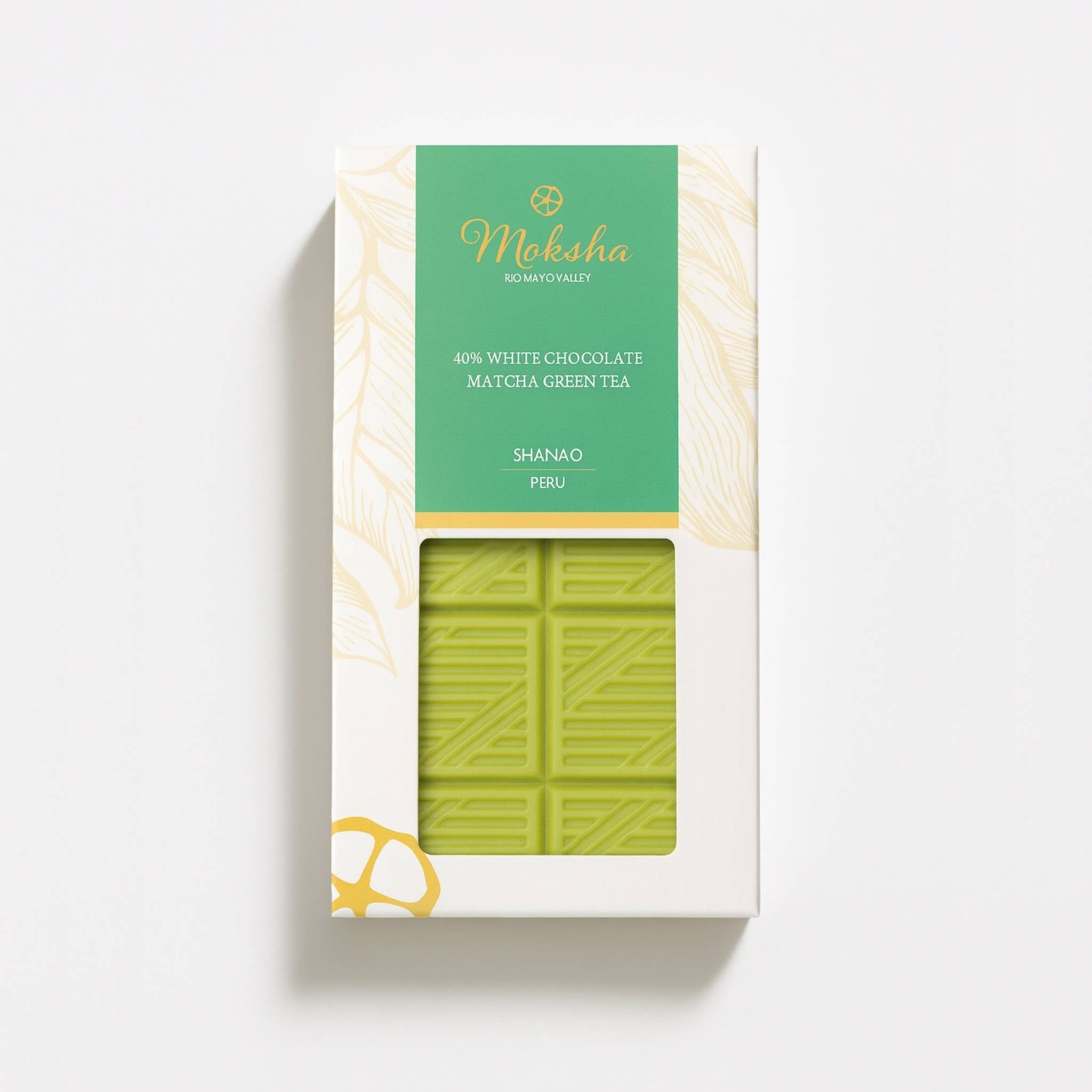 Moksha 40% White Chocolate Matcha Green Tea bar in white and gold packaging with a green label and a window showing the pale green matcha chocolate.