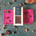 70% dark chocolate bar with cacao nibs and chocolate pieces on a green surface