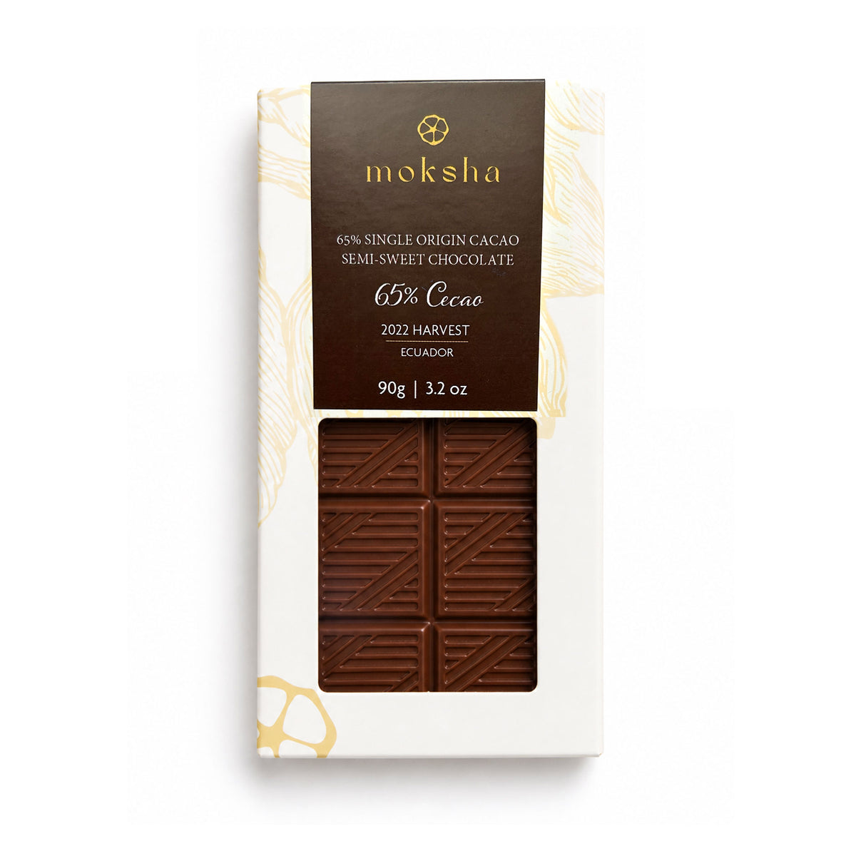 A 90g bar of Moksha 65% Cacao Semi-Sweet Chocolate from 2022 Harvest in Ecuador, shown in its white packaging with a clear window displaying the chocolate.