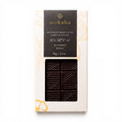 A top-down photograph of a packaged Moksha 80% Single Origin Dark Chocolate bar from the 2023 Bolivia harvest, 90g (3.2 oz), on a plain white background. The packaging features gold botanical leaf patterns and a die-cut window showing the geometric patterned dark chocolate bar inside.