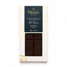 Moksha 80% Itenez single-origin dark chocolate bar from Bolivia with perfectly tempered dark chocolate visible through elegant white and gold packaging.