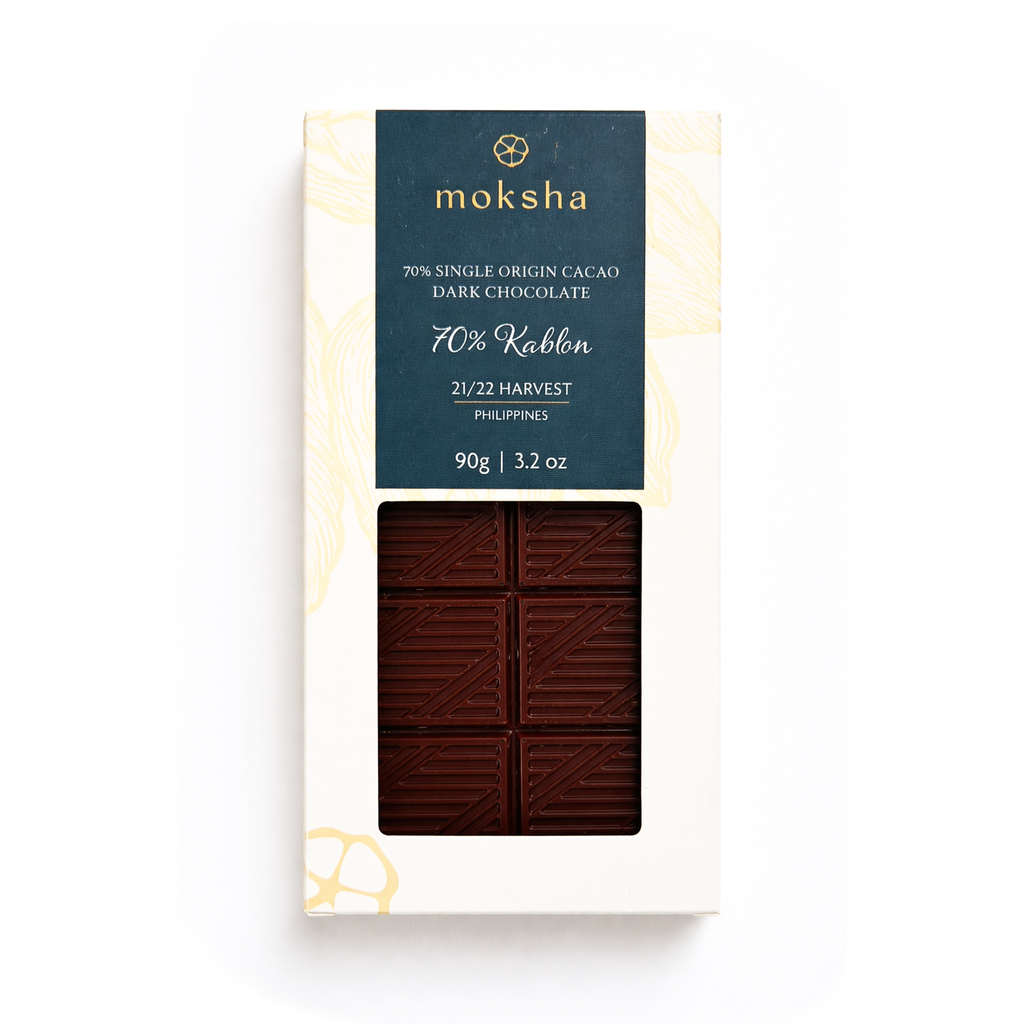 Moksha Chocolate Kablon Farms 70% single-origin dark chocolate bar in white packaging with a blue label and window showing the chocolate, photographed on a light gray background.