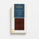 Moksha 70% single origin dark chocolate bar from Kokoa Kamili, Tanzania, in a white box with a deep blue label and a window displaying the chocolate.