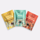 Three packages of Moksha chocolate with different mushroom varieties on a white background