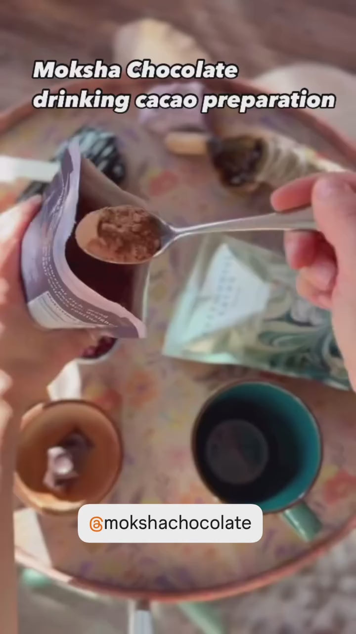 Video of artisan-crafted drinking cacao being prepared with organic cacao powder and hot water for a mindful chocolate experience.