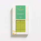 Moksha 40% White Chocolate Matcha Green Tea bar in white and gold packaging with a green label and a window showing the pale green matcha chocolate.